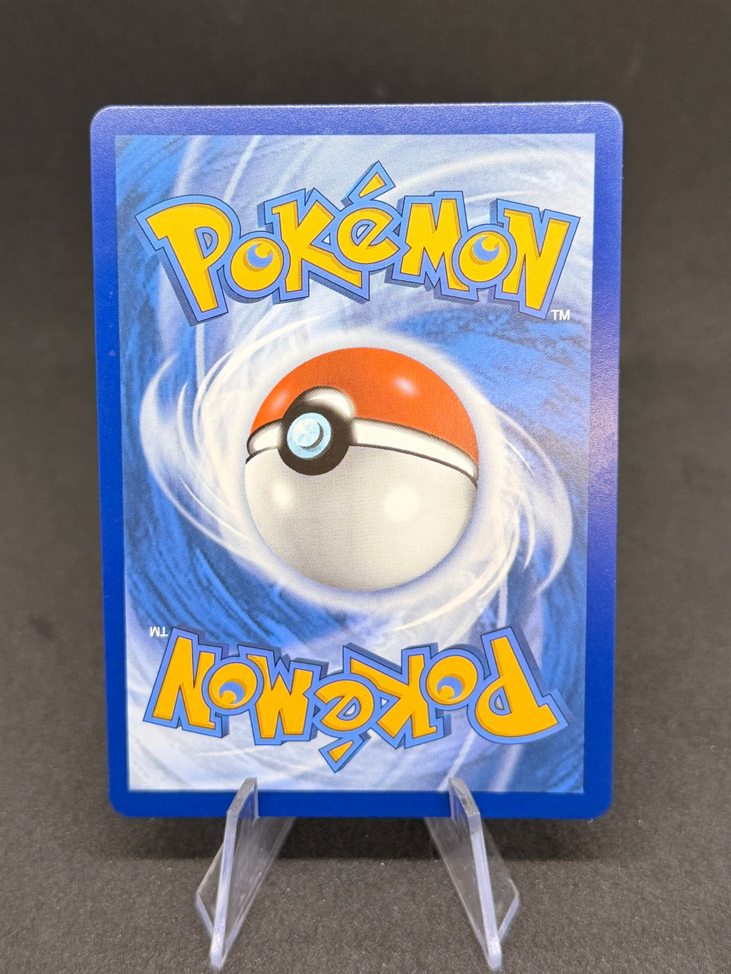 Pokémon trading card in a blue protective case on a dark background