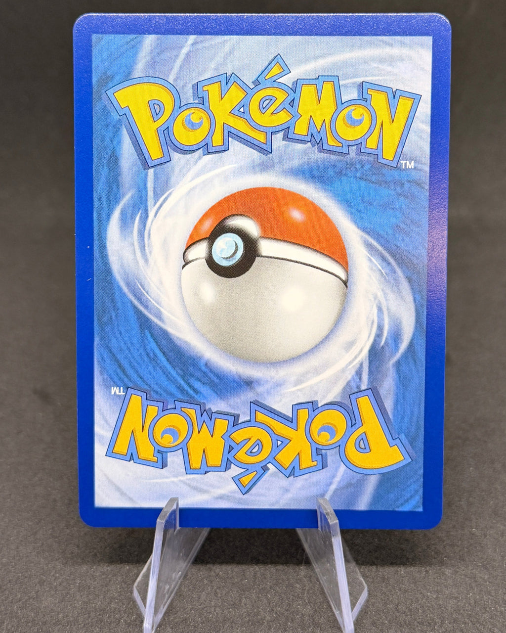 Pokémon trading card with blue border and central logo on a dark background