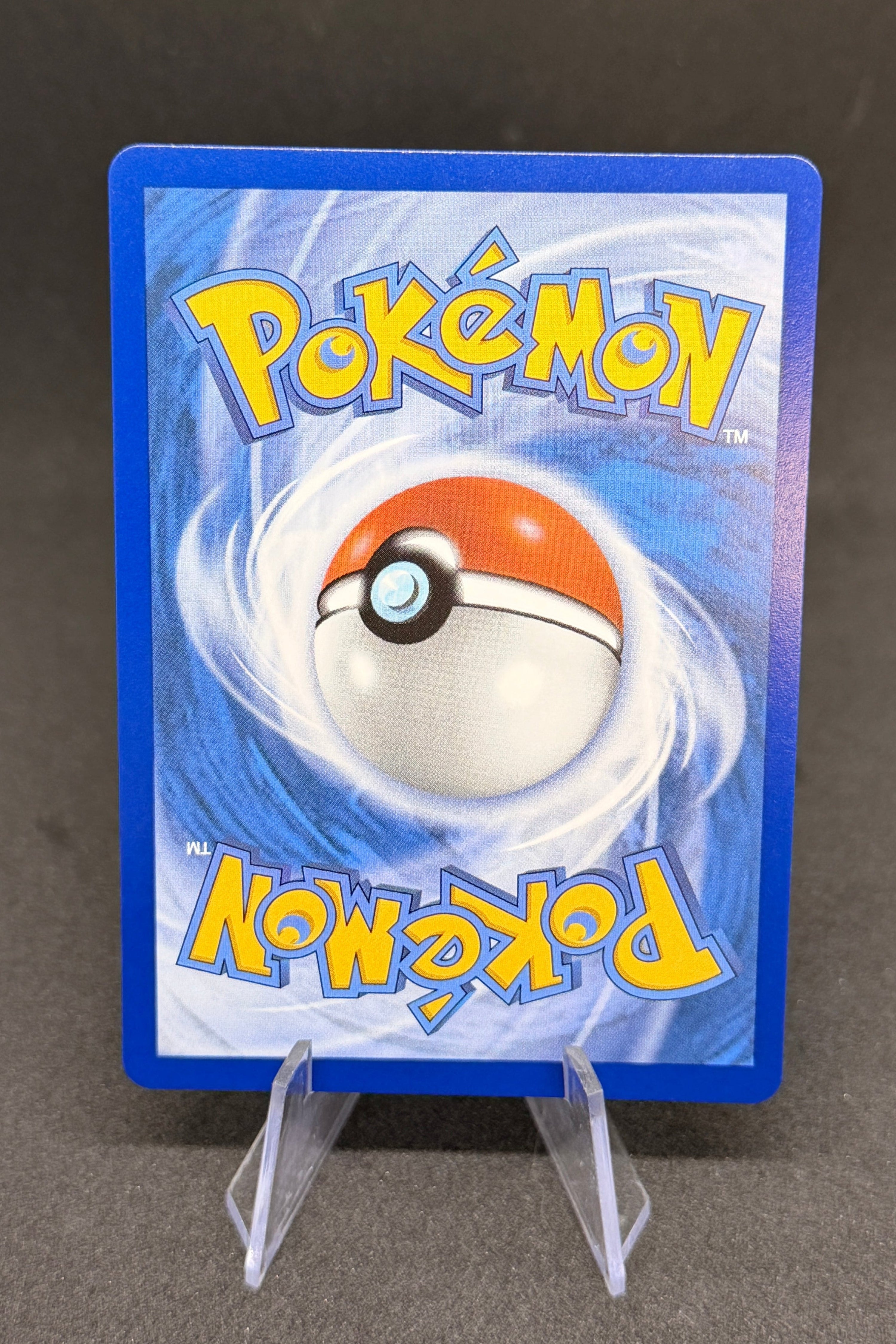 Pokémon trading card with blue border and Pokéball design on a dark background
